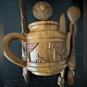 vintage, hand-carved wooden teapot, featuring jungle scenes
